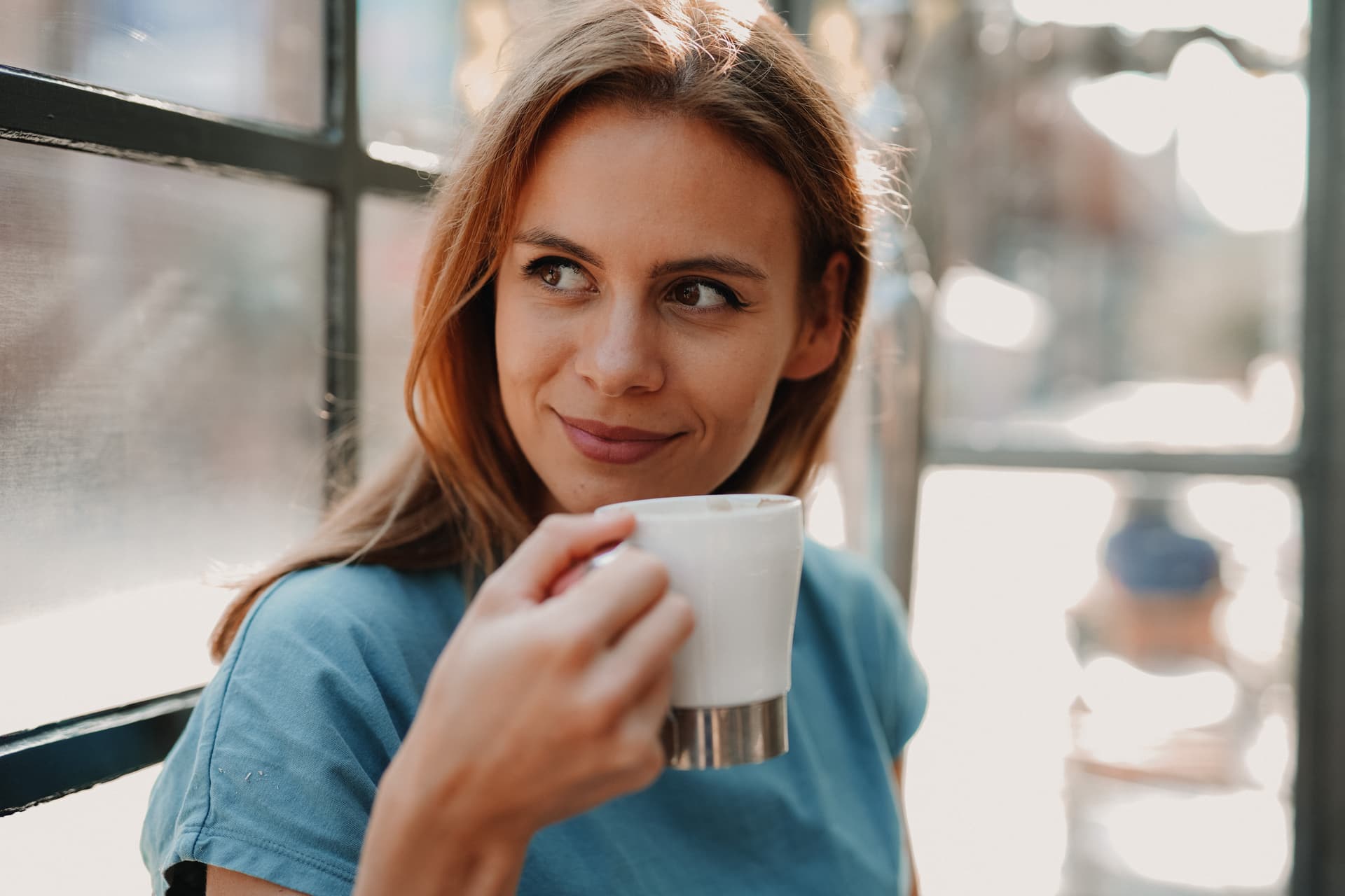 Happy lady with coffee looking to side