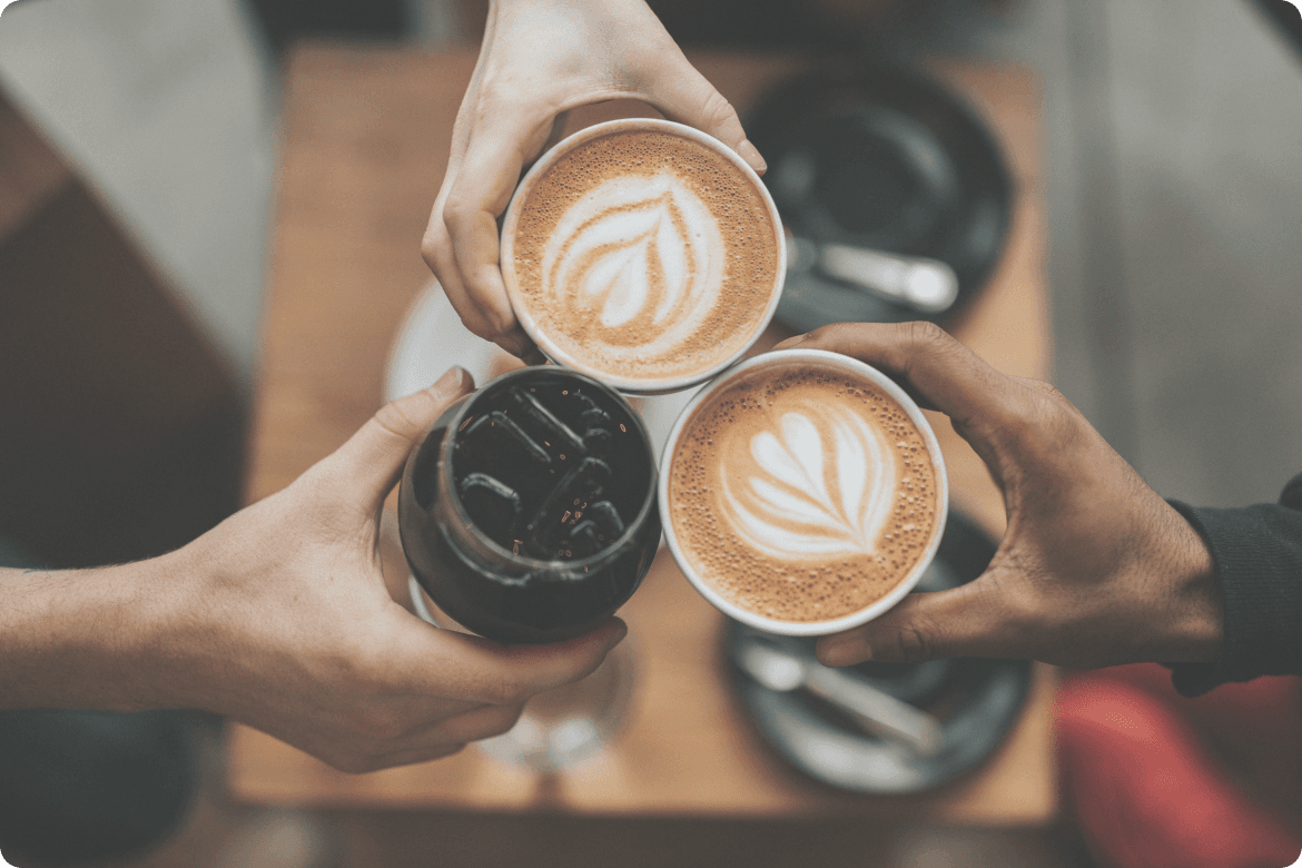 Image of three people toasting coffee cups